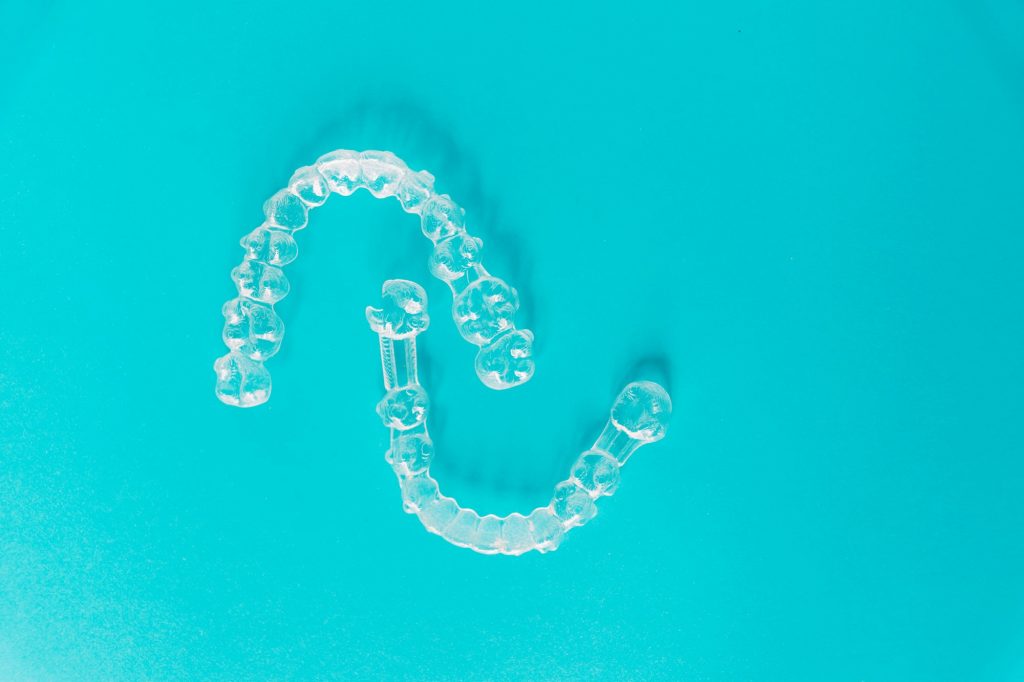 Top view of transparent aligners isolated on a blue background