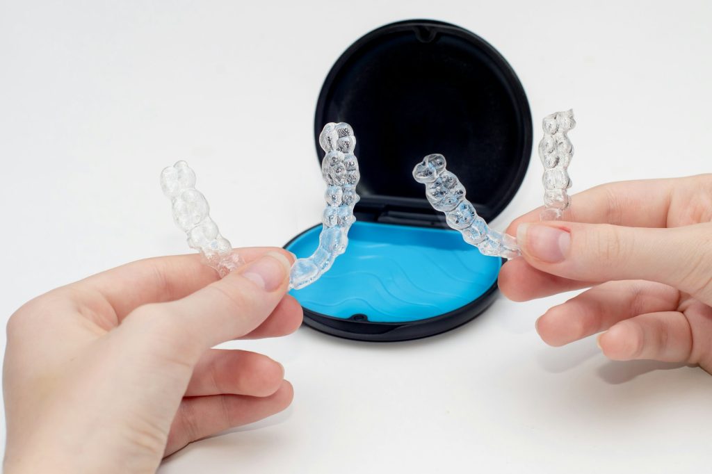 Transparent teeth aligners in a box. Invisible braces. Clear teeth straighteners.